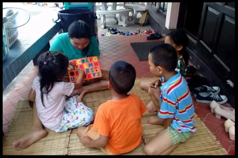 Teach Our Kids: staff teaching children